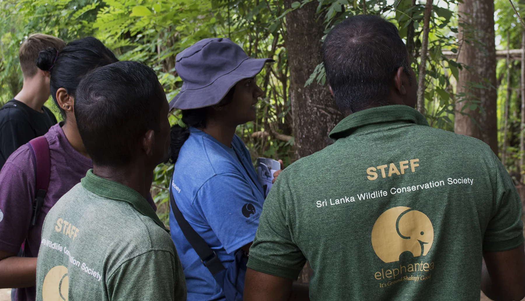 SLWCS staff and a volunteer talking with villagers